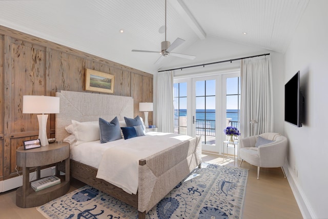 bedroom featuring lofted ceiling with beams, wood walls, light hardwood / wood-style floors, ceiling fan, and access to exterior