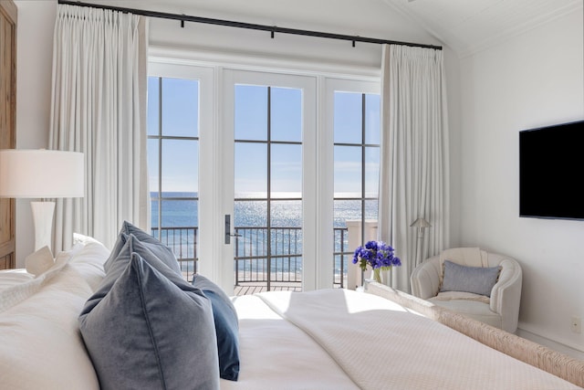 bedroom featuring lofted ceiling, multiple windows, access to outside, and a water view