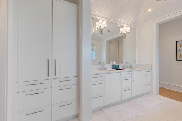 bathroom featuring an inviting chandelier, wood ceiling, and vanity