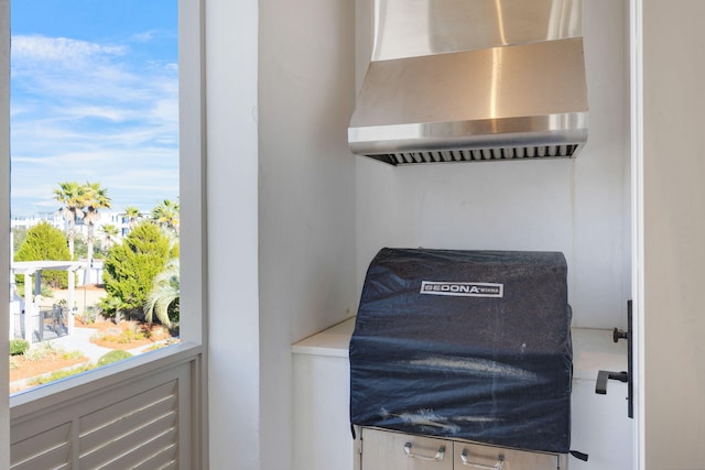 room details with wall chimney range hood