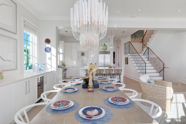 dining area featuring ornamental molding, wine cooler, hardwood / wood-style flooring, and a chandelier