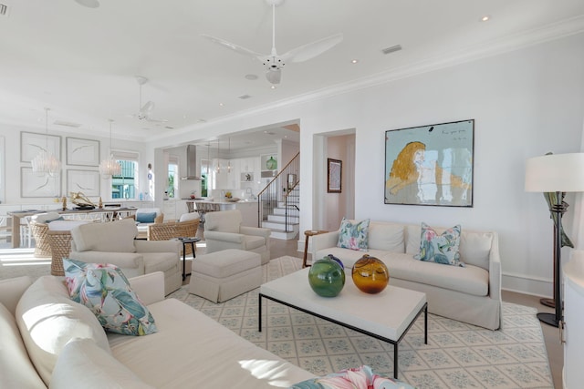 living room with ornamental molding and ceiling fan