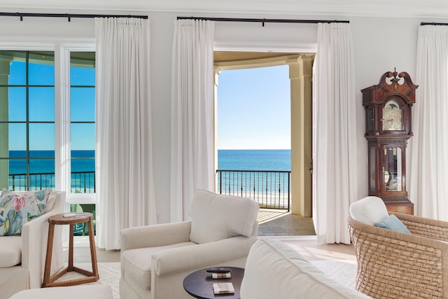 bedroom featuring multiple windows, access to outside, and a water view