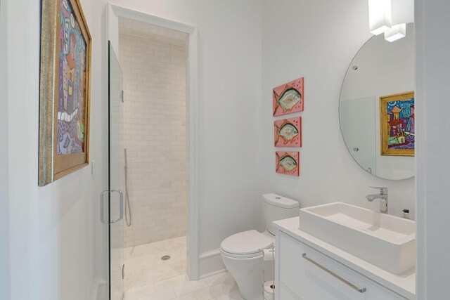 bathroom featuring toilet, tile patterned floors, a shower with shower door, and vanity