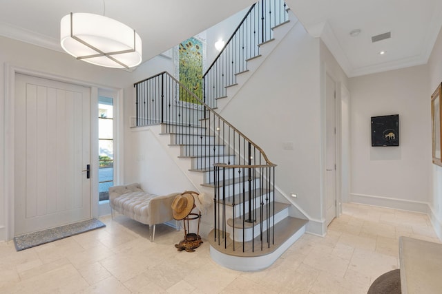 entryway featuring ornamental molding