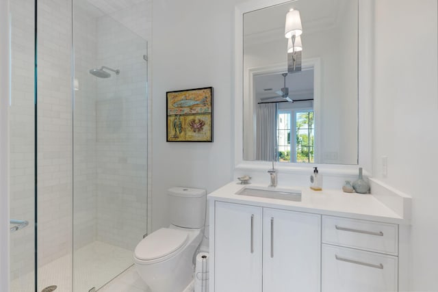 bathroom with ceiling fan, an enclosed shower, vanity, and toilet