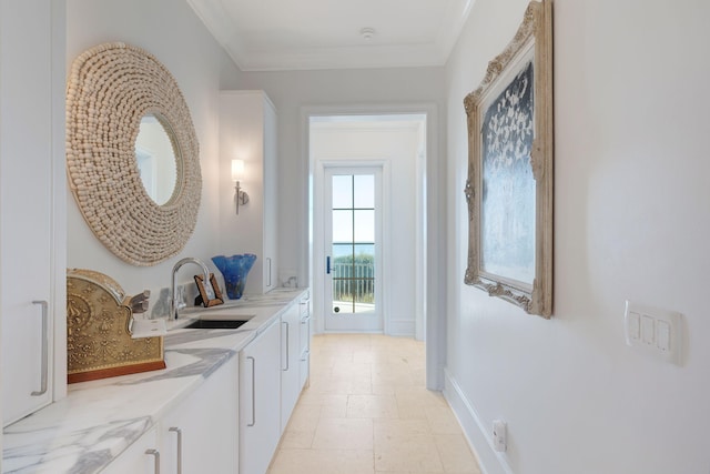 hall featuring sink and ornamental molding