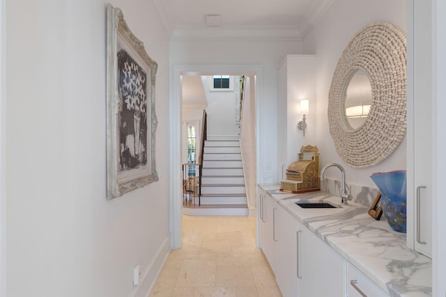 corridor featuring crown molding and sink