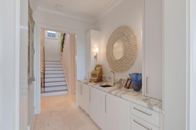 hallway with crown molding and sink