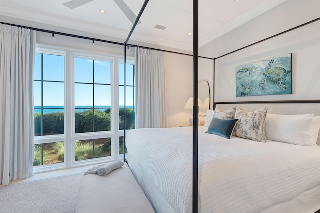 bedroom featuring ceiling fan, crown molding, and a water view