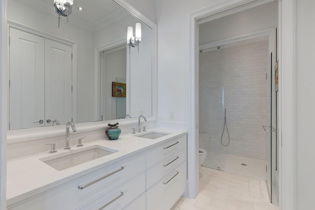 bathroom featuring tiled shower, toilet, tile patterned floors, vanity, and crown molding