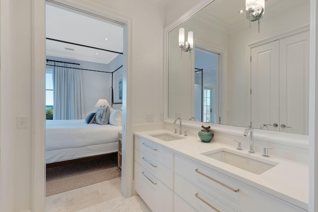 bathroom with plenty of natural light, ornamental molding, and vanity