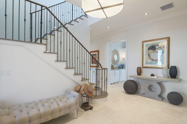 staircase featuring crown molding