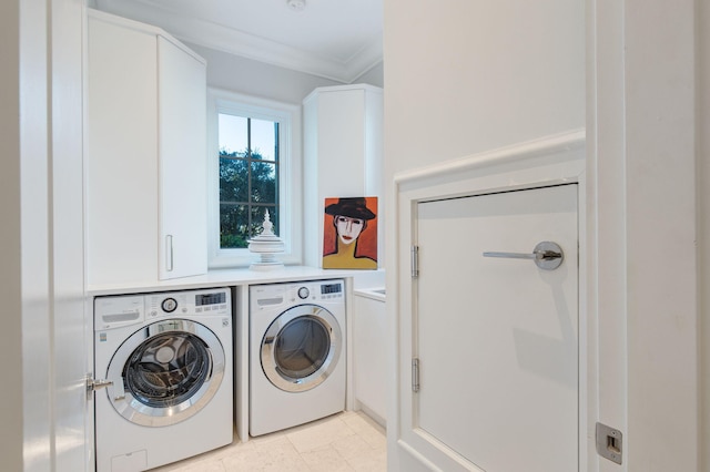 laundry area featuring cabinets, light tile patterned flooring, crown molding, and washing machine and clothes dryer