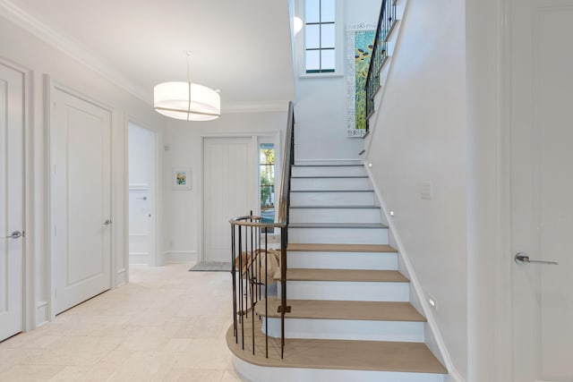 staircase featuring ornamental molding