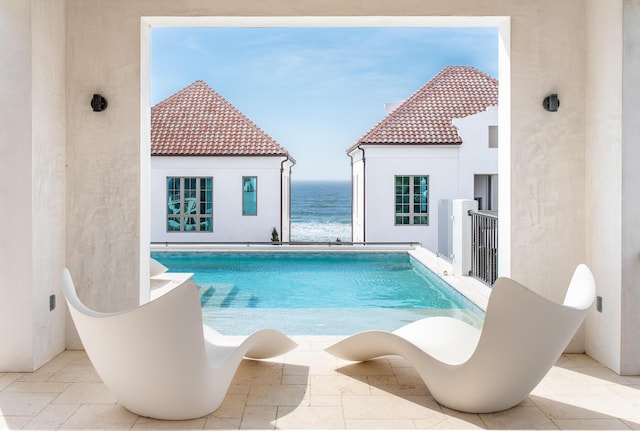 view of pool featuring a water view