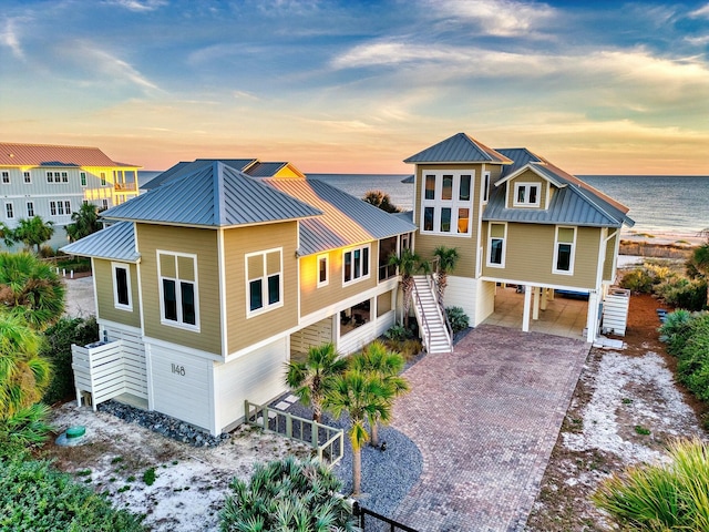 view of front of property with a water view and a carport