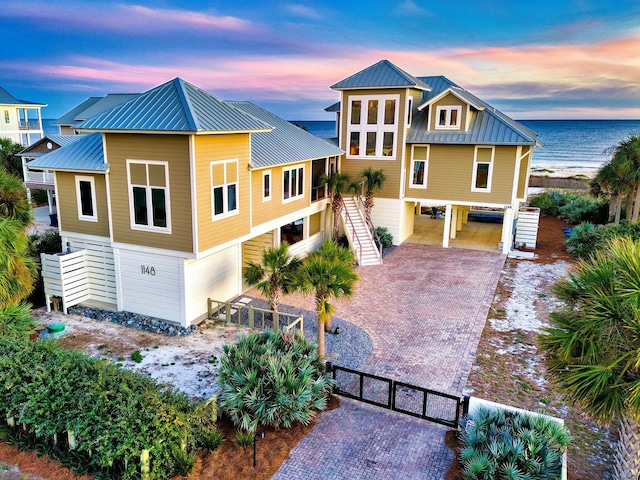 view of front of property with a carport and a water view