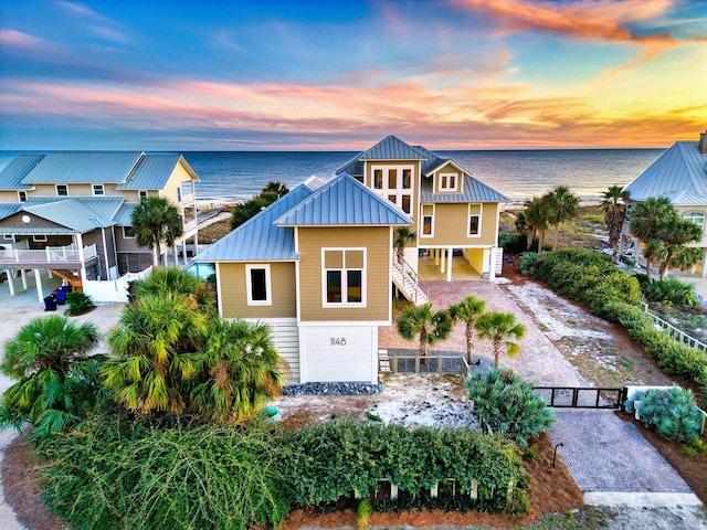 view of front of house with a water view