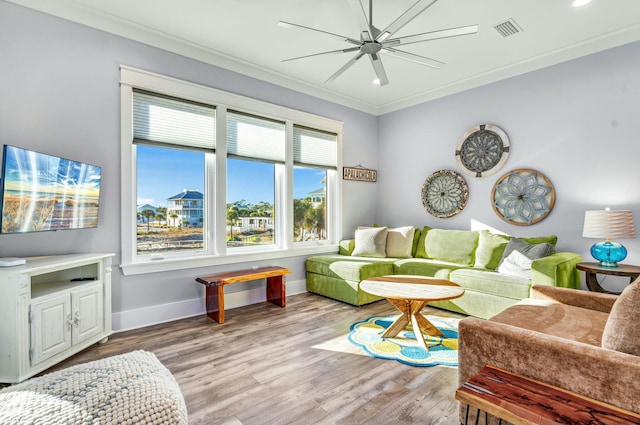 living room with ceiling fan, crown molding, and light hardwood / wood-style floors