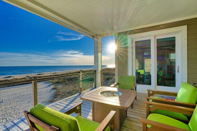 balcony with a water view and a beach view