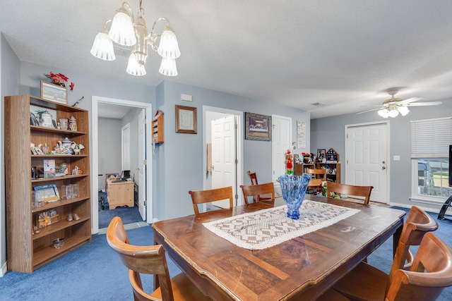 dining space with ceiling fan with notable chandelier, a textured ceiling, and carpet flooring