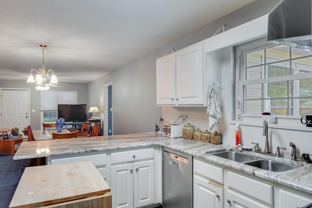 kitchen with stainless steel dishwasher, white cabinets, an inviting chandelier, and sink