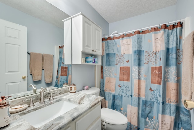 bathroom with toilet, a shower with shower curtain, vanity, and a textured ceiling