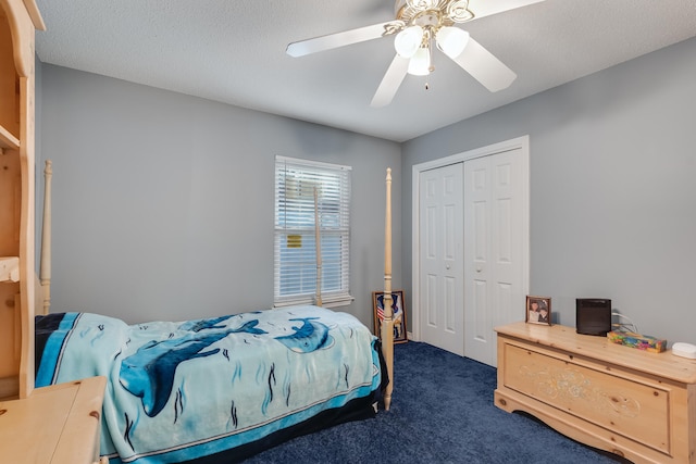 carpeted bedroom with a textured ceiling, ceiling fan, and a closet