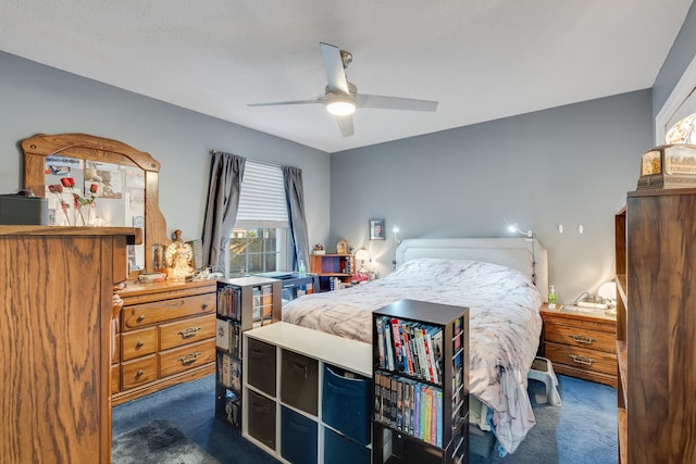 bedroom featuring ceiling fan and dark carpet