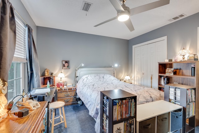 carpeted bedroom with a closet and ceiling fan