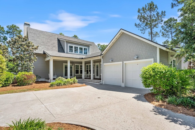 view of front of property featuring covered porch and a garage