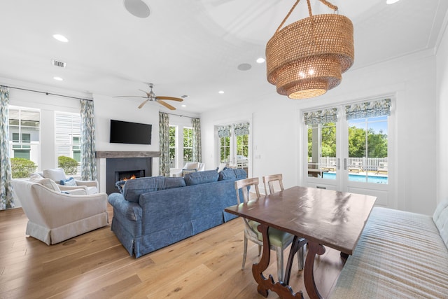 living room with light hardwood / wood-style floors, plenty of natural light, and ceiling fan