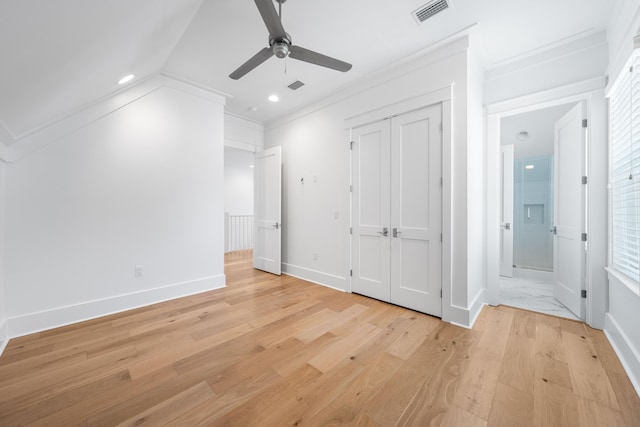 unfurnished bedroom with a closet, light hardwood / wood-style flooring, ceiling fan, and ornamental molding