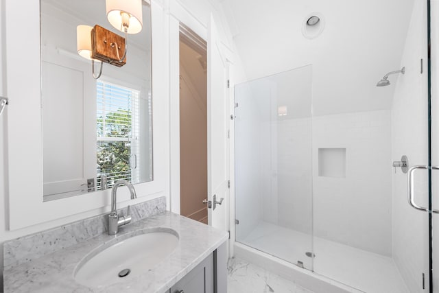 bathroom featuring vanity and a shower with door