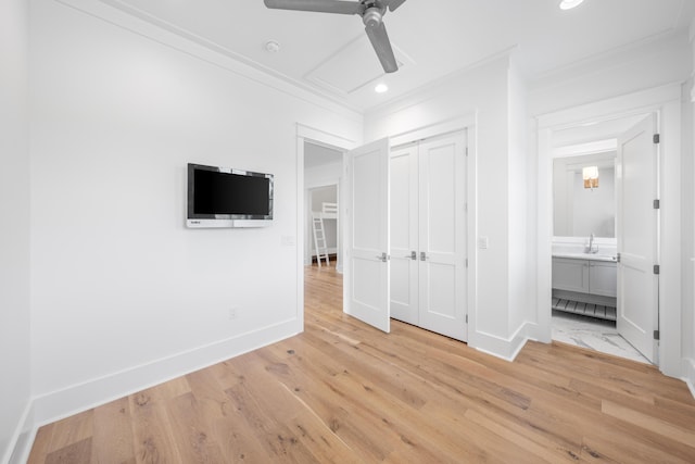 unfurnished bedroom featuring crown molding, ceiling fan, a closet, and light hardwood / wood-style floors