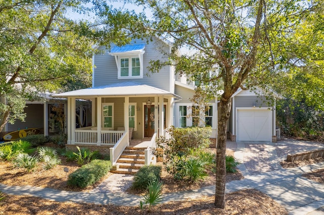 view of front of home with covered porch, an outdoor structure, and a garage