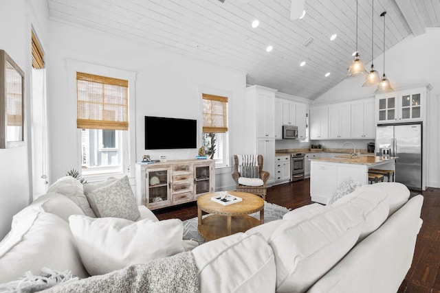 living room with wood ceiling, dark wood-type flooring, sink, high vaulted ceiling, and beamed ceiling