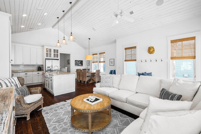 living room with beam ceiling, ceiling fan, dark wood-type flooring, high vaulted ceiling, and wood ceiling