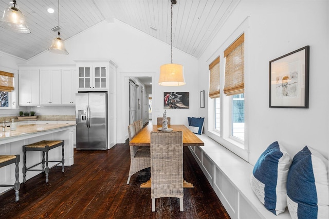 dining space featuring dark hardwood / wood-style flooring, high vaulted ceiling, and wooden ceiling