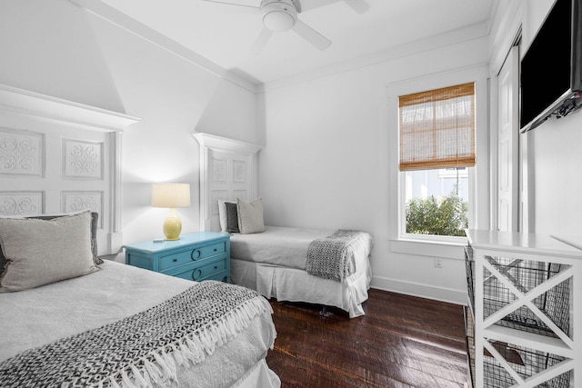 bedroom featuring ornamental molding, ceiling fan, and dark wood-type flooring