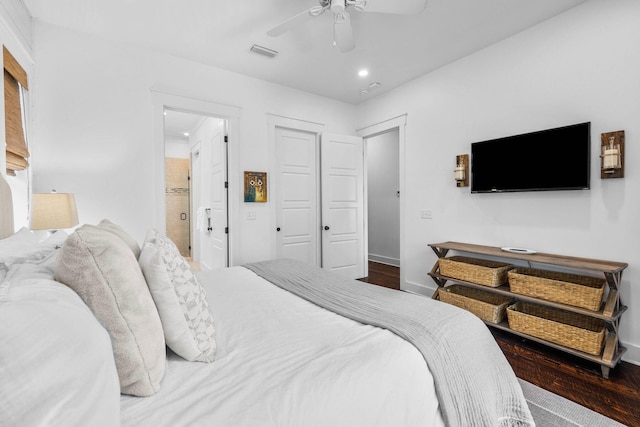 bedroom with hardwood / wood-style floors, ensuite bath, and ceiling fan