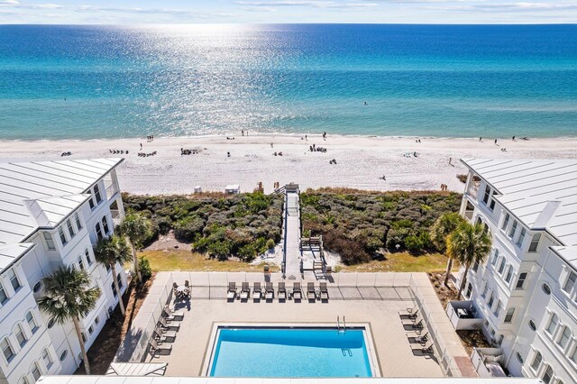 birds eye view of property with a water view and a view of the beach