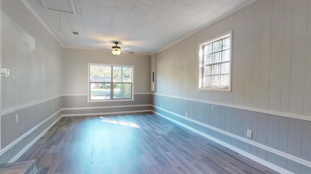 unfurnished room with plenty of natural light, ornamental molding, ceiling fan, and hardwood / wood-style floors