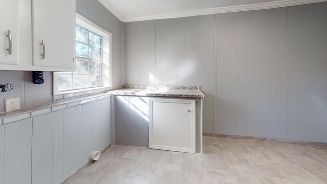 kitchen featuring ornamental molding and white cabinetry