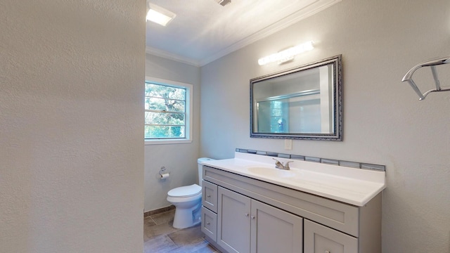 bathroom with toilet, vanity, and crown molding