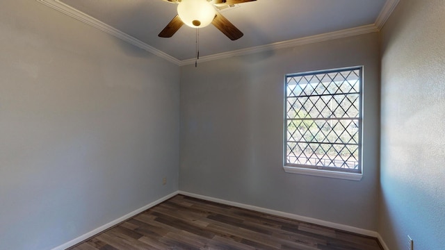 empty room with crown molding, a wealth of natural light, and dark hardwood / wood-style floors