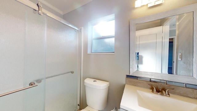 bathroom featuring crown molding, an enclosed shower, vanity, and toilet