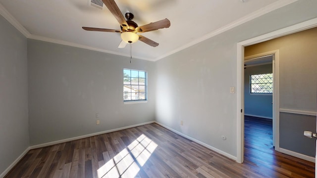 empty room with ceiling fan, crown molding, and wood-type flooring