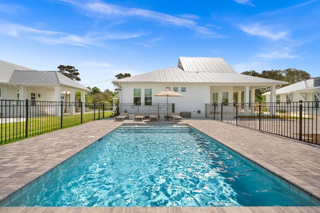 view of pool featuring a patio and fence